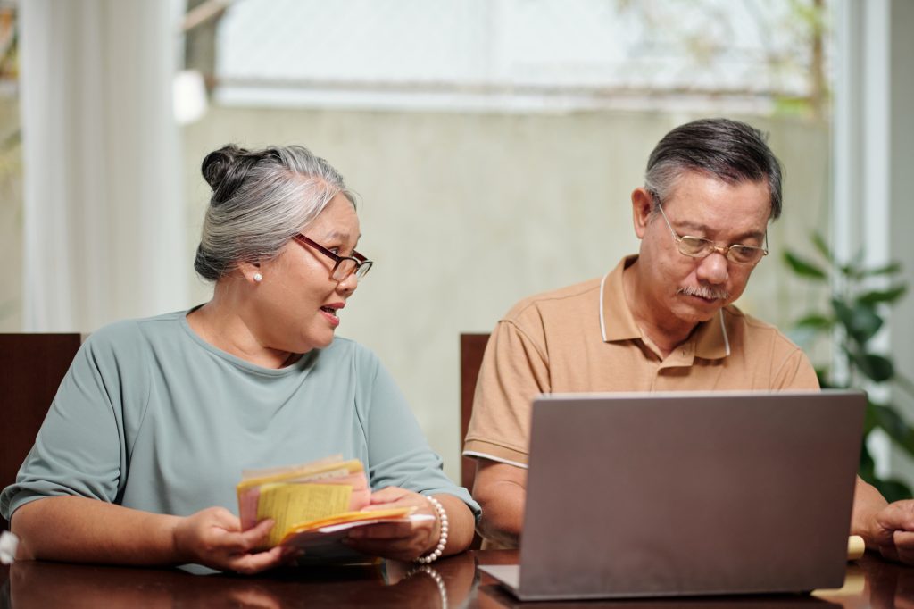 A retired couple going through their bills and finances together.