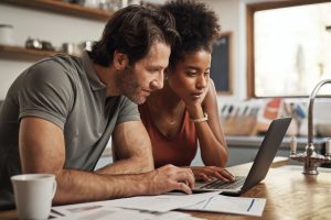 A couple in front of a computer.
